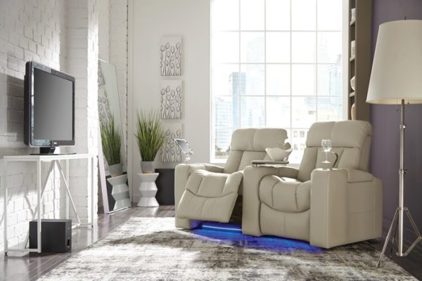 Palliser Paragon home theater seats shown in white leather as a 2 seat group in a living room with wine glass holders and LED
