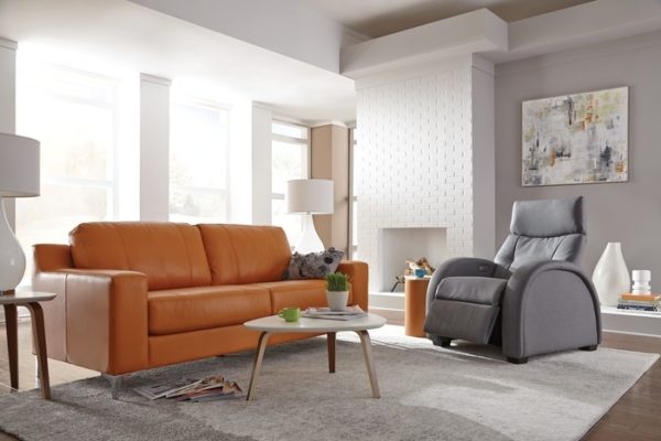 Palliser zero gravity recliner in living room setting with orange loveseat